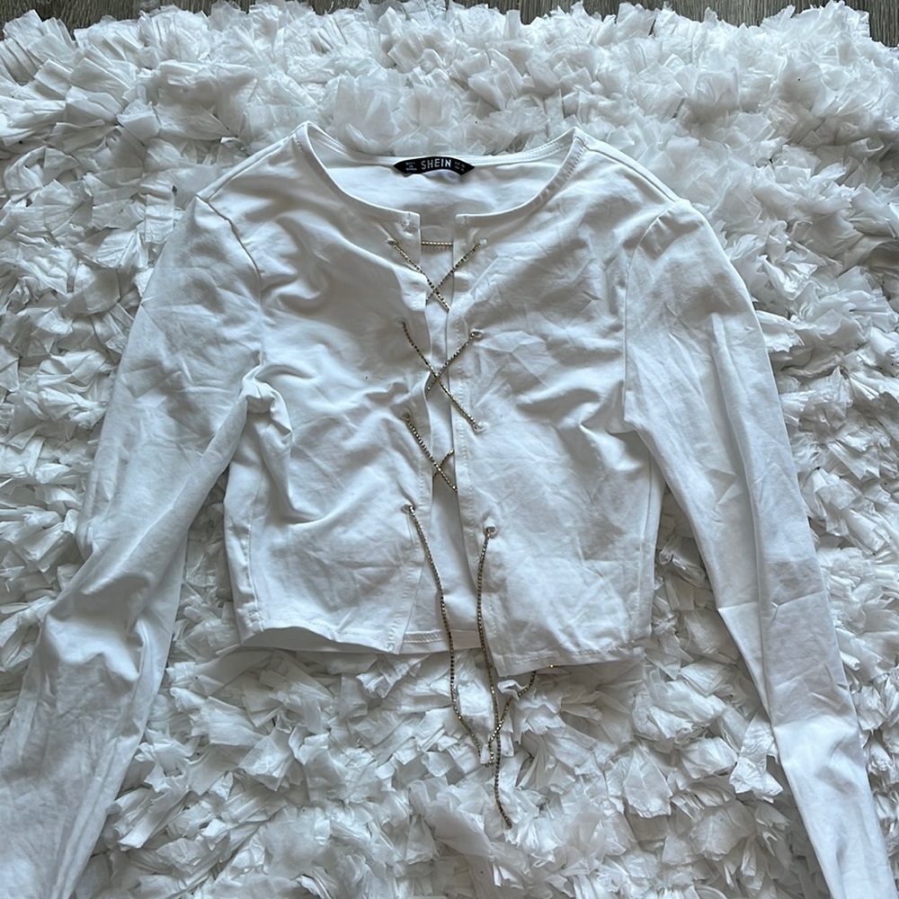 white long sleeve slightly cropped open front shirt with criss cross chain ties